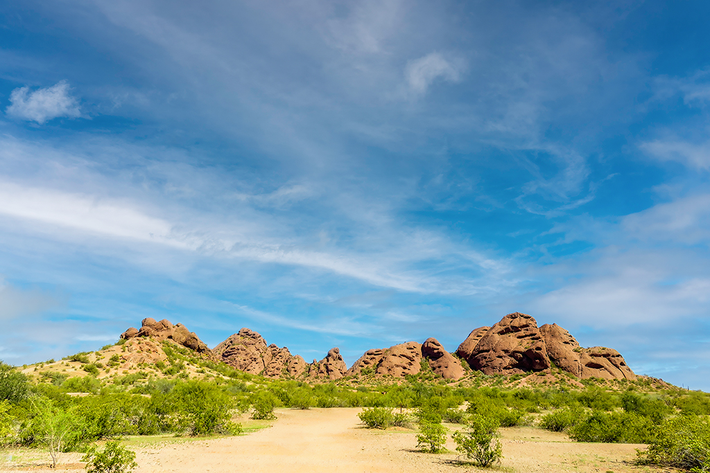 Towering red rock formations of Papago Park, beneath a brilliant blue sky, surrounded by the quiet beauty of the desert. Phoenix, Arizona, USA