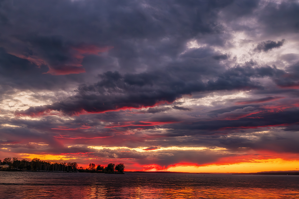 Dark clouds meet a burning horizon. Andrew Haden Park, Ottawa, Ontario
